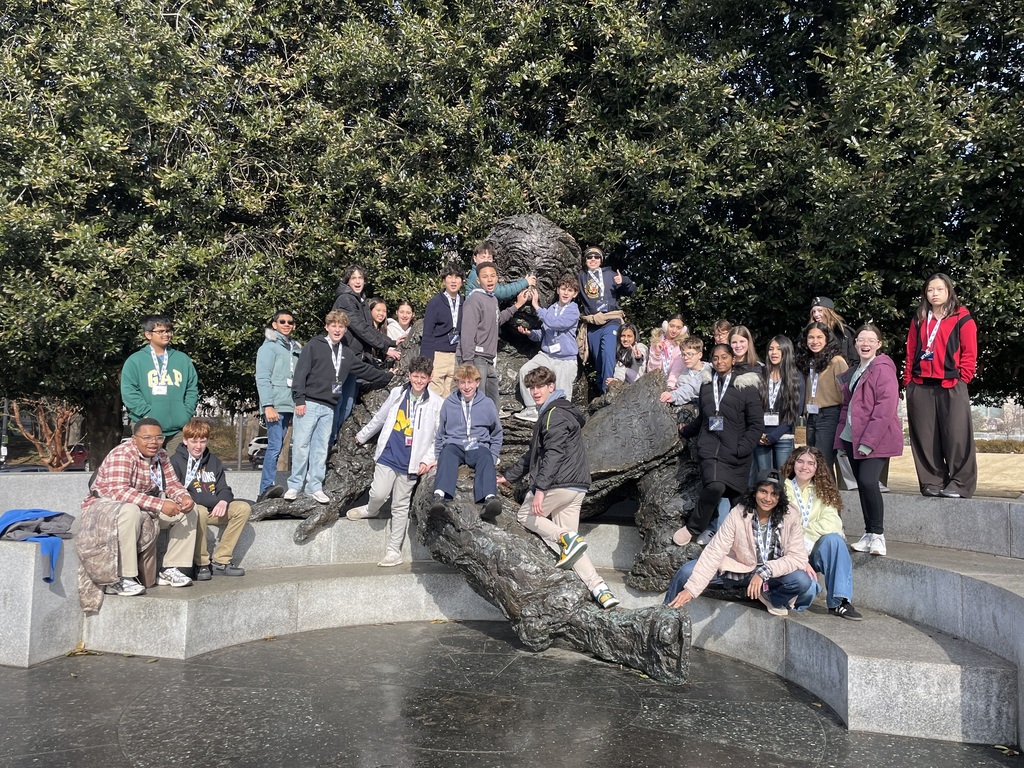 Students standing in a group in front of a sculpture in D.C.