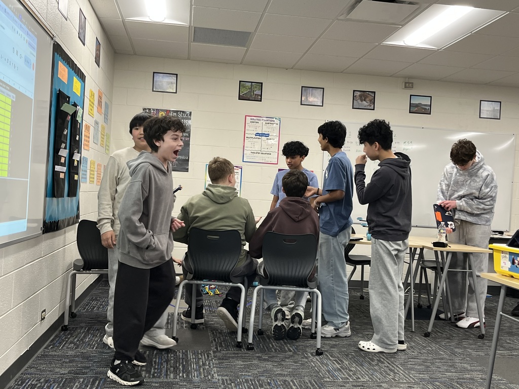 Students standing and building their battle bots.