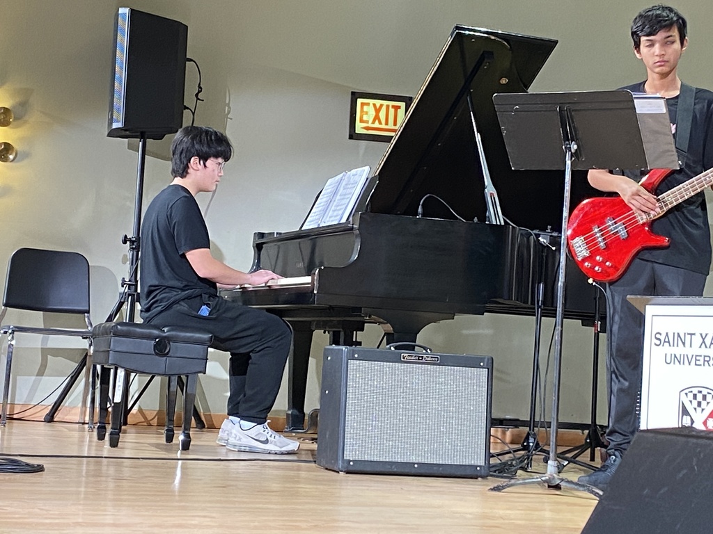 Students playing the piano and guitar.