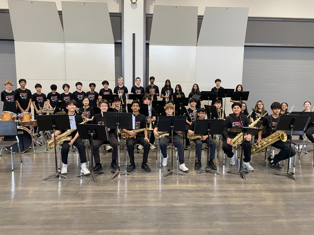 Students standing together in a group with their instruments.
