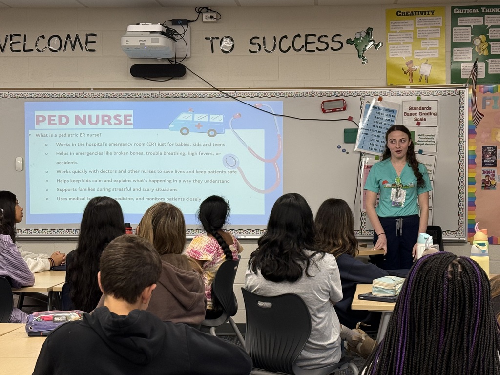 Nurse presenting to a group of students.