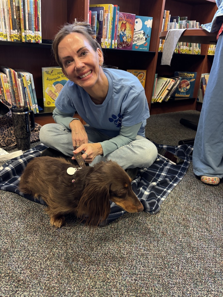 Mrs. Schenk sitting with her dog.