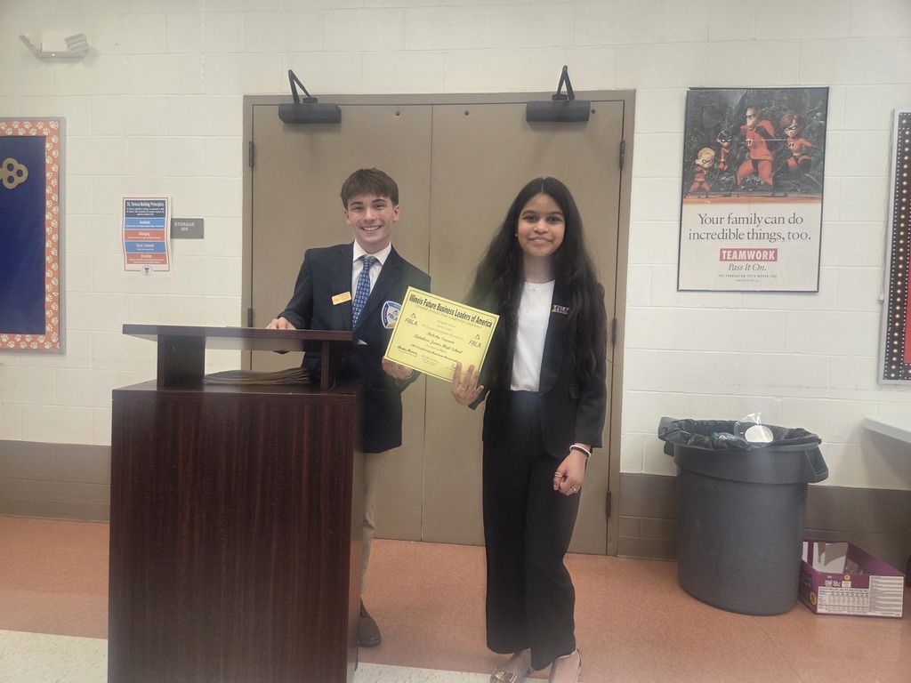 Two students holding a certificate.