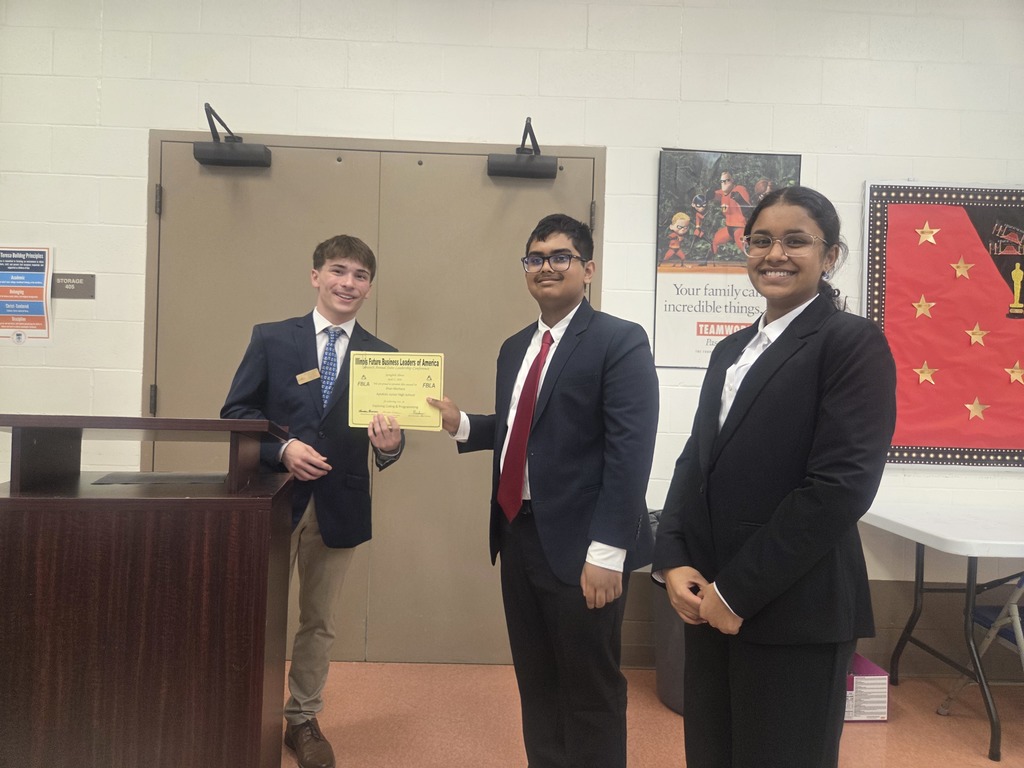 Students standing with a certificate.