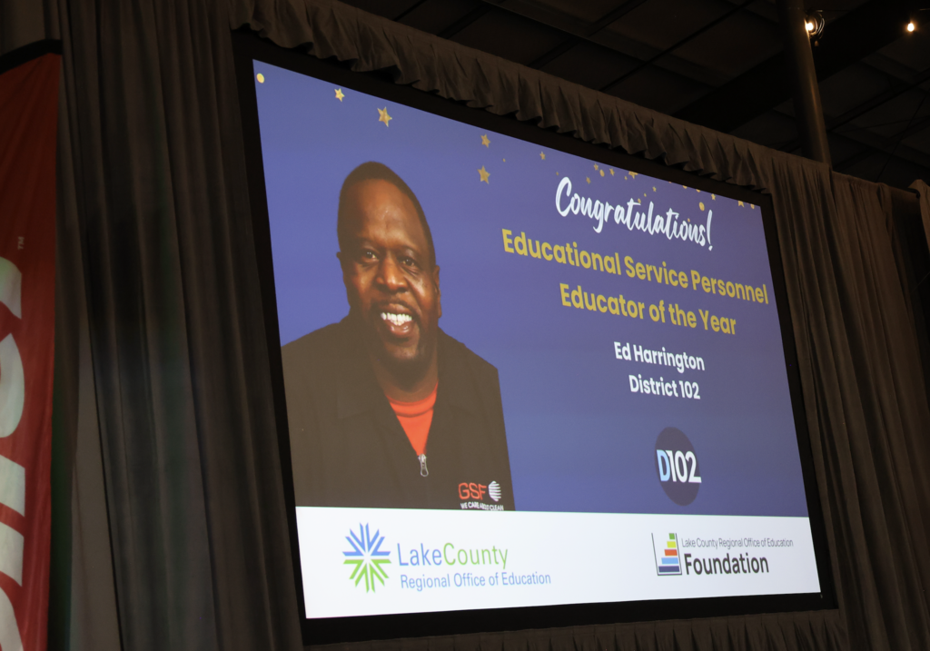 Screen of Mr. Ed as he wins the Educator of the Year award in the educational service personnel category.