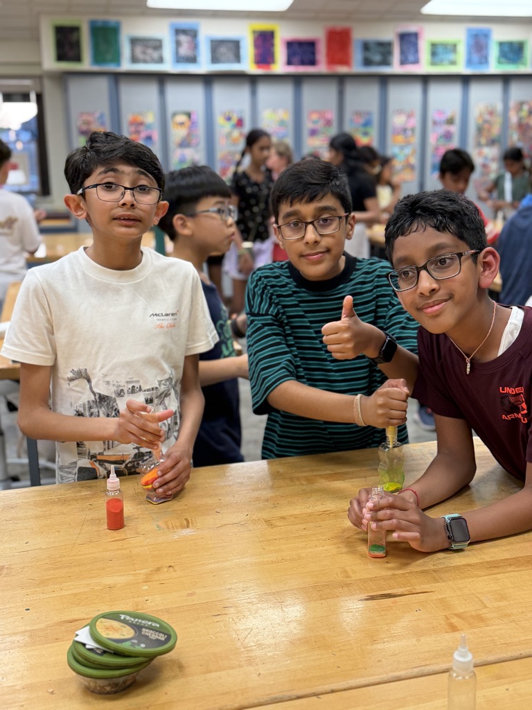 3 boys making sand art.
