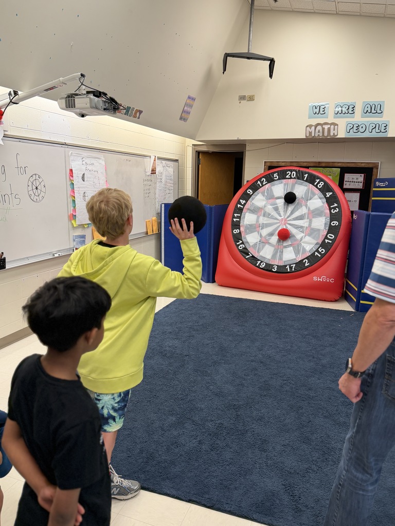 Student throwing a ball at a target.