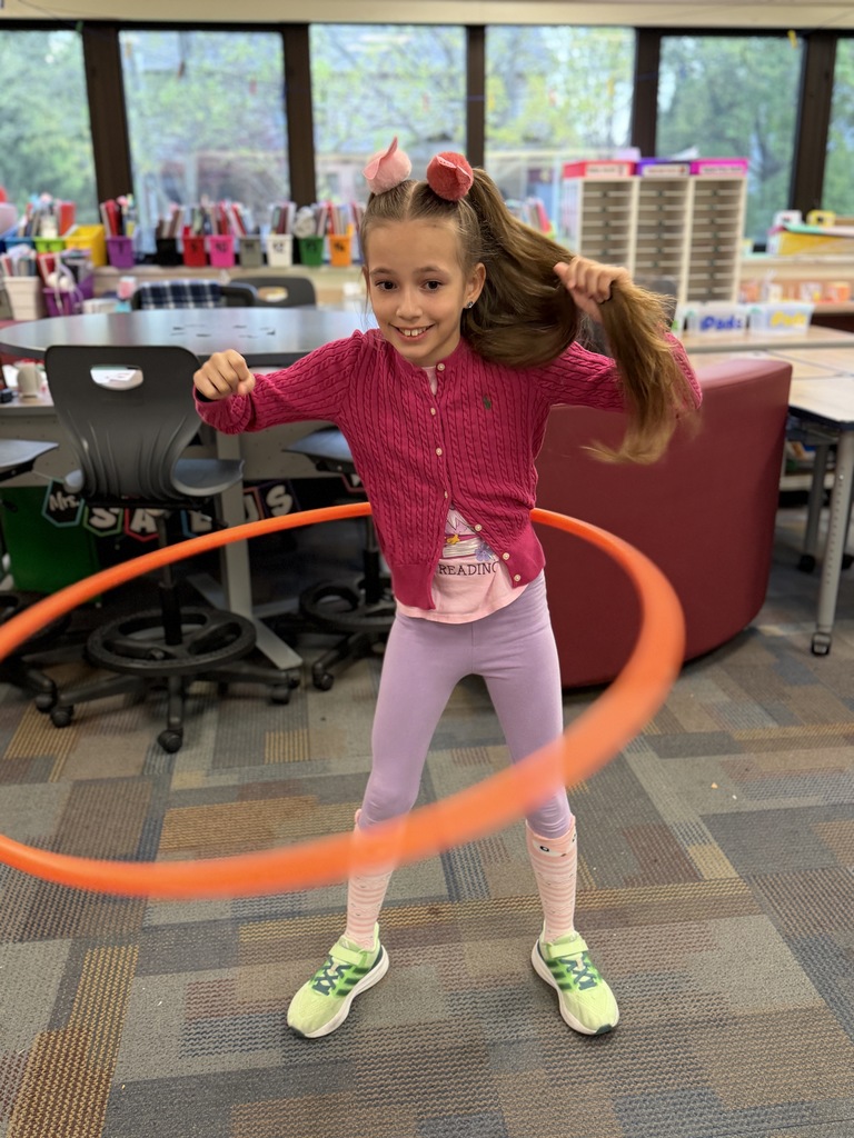 Girl smiling with a hula hoop.