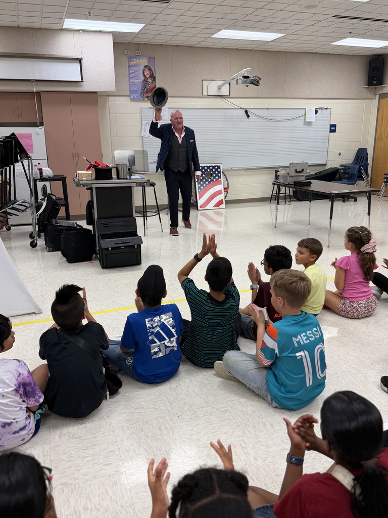 Magician holding up his hat.