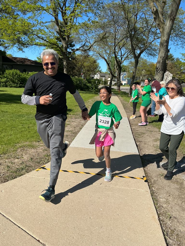 Dad and daughter running.