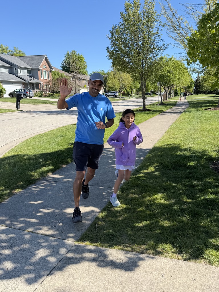 Father and daughter running and waving.