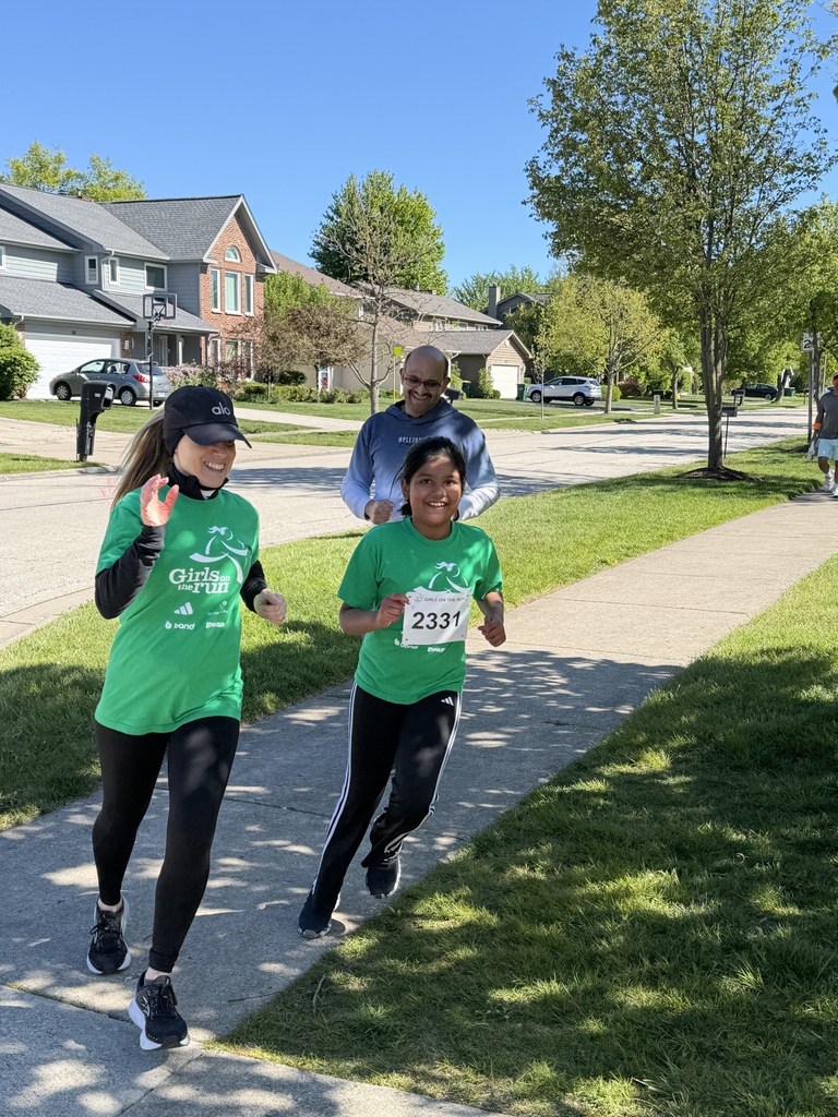 Mom and daughter running waving and smiling.