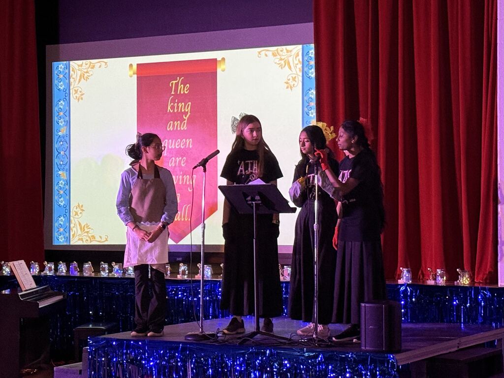 Students talking on stage.