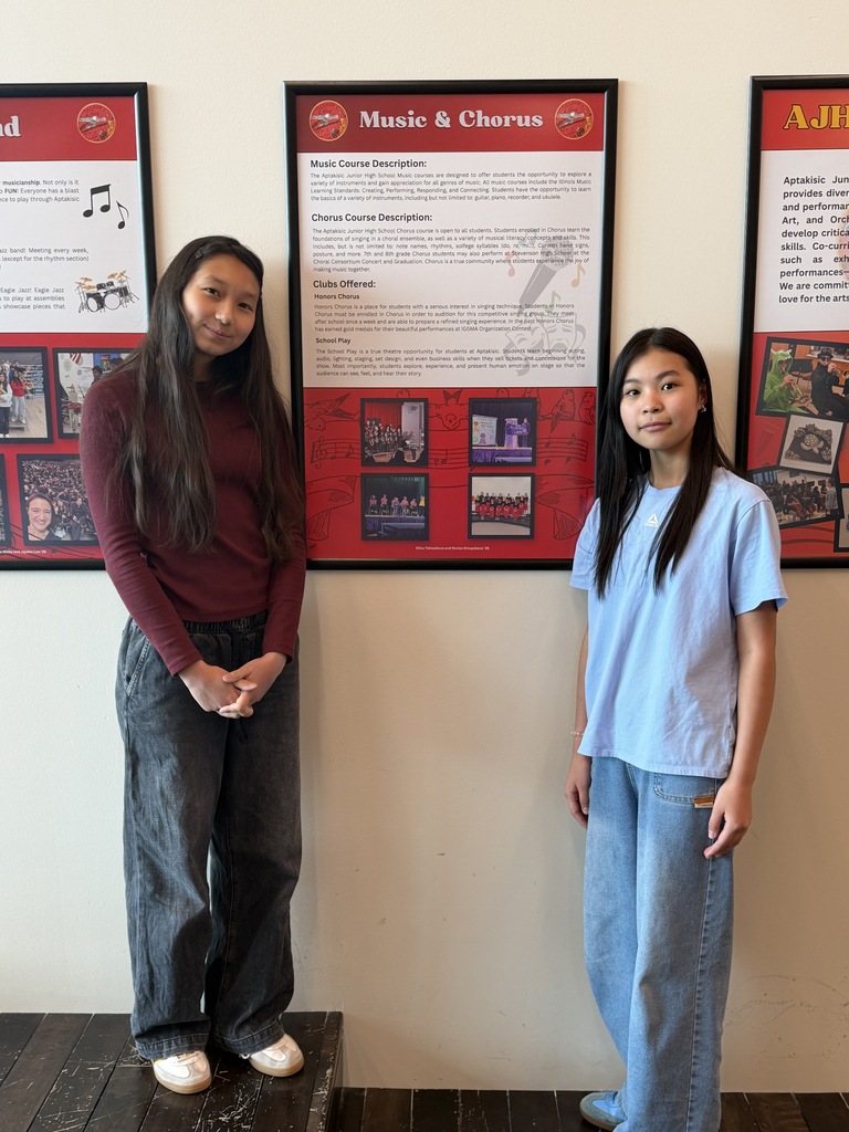 2 students standing by their poster.