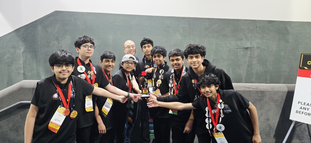 Students standing with a trophy.