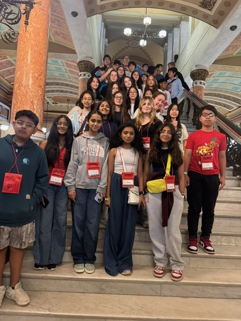 Students standing in a group on steps.