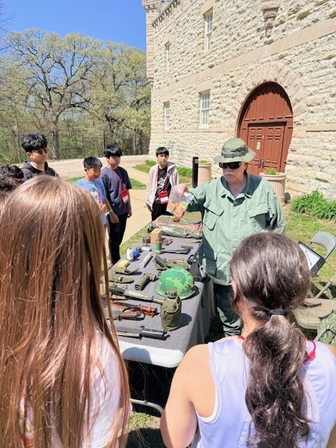 Students looking at military equipment.