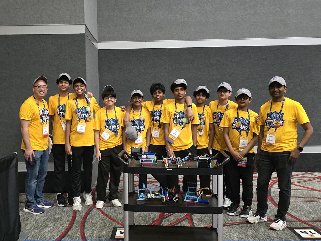 Titans team posing with their robots and Mr. Cho