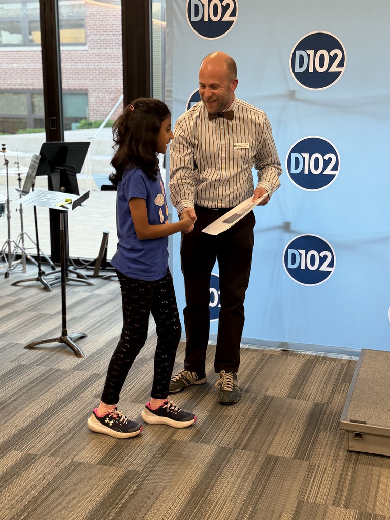 President Sklansky standing with a student giving handshake. 