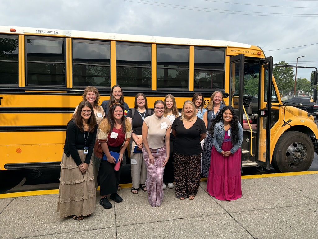 Staff members in front of the bus.