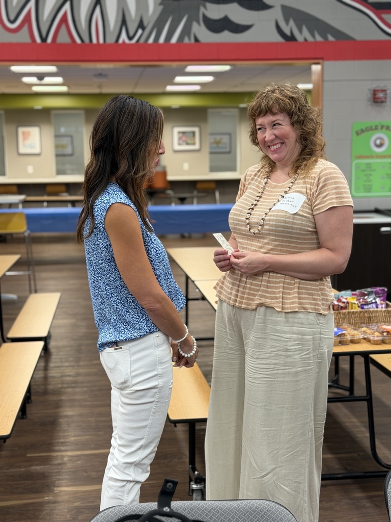 Staff members talking and smiling.