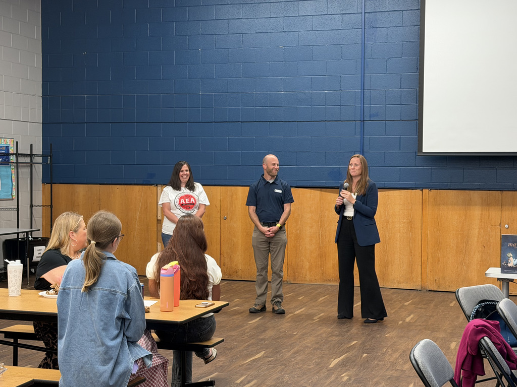 Staff standing in the front speaking to the group.