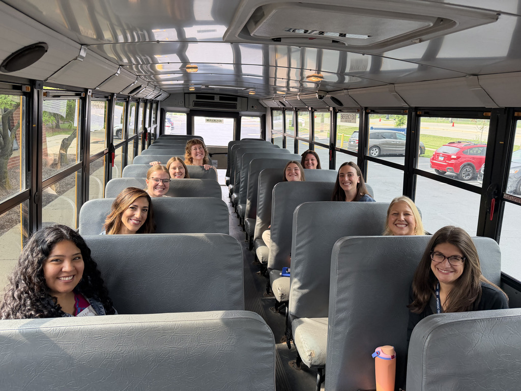 Staff riding a bus.