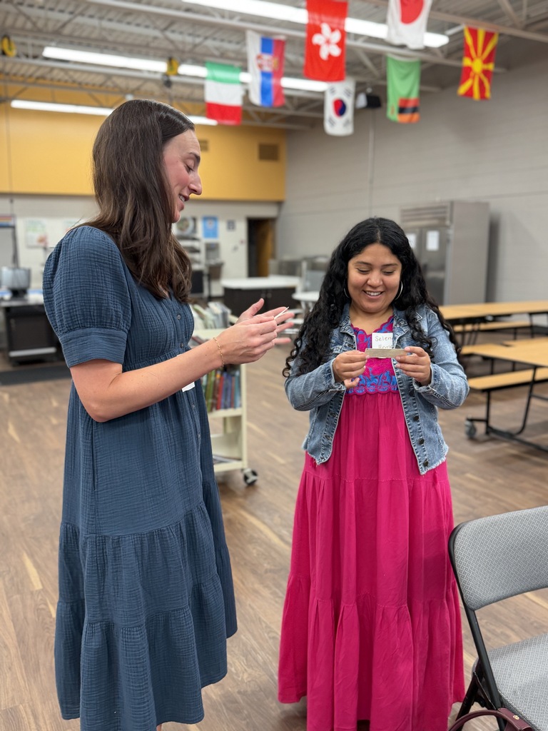 Staff members talking to one another in the lunchroom.