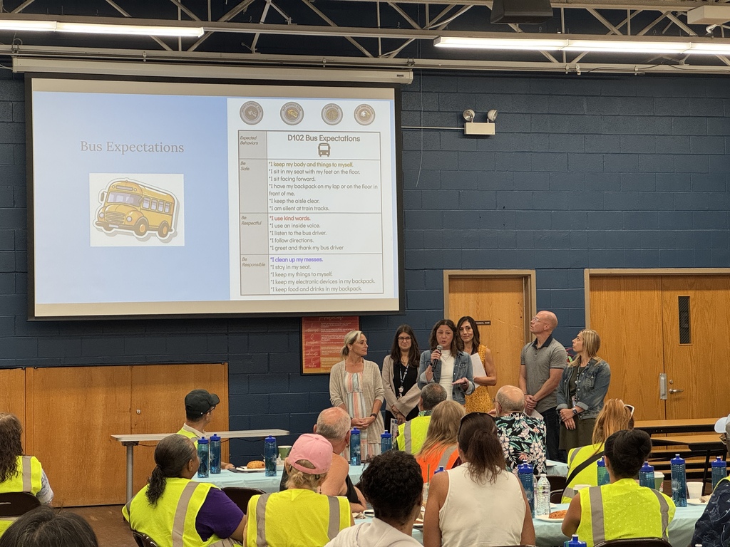 Admin showing a presentation on the screen about bus expectations.