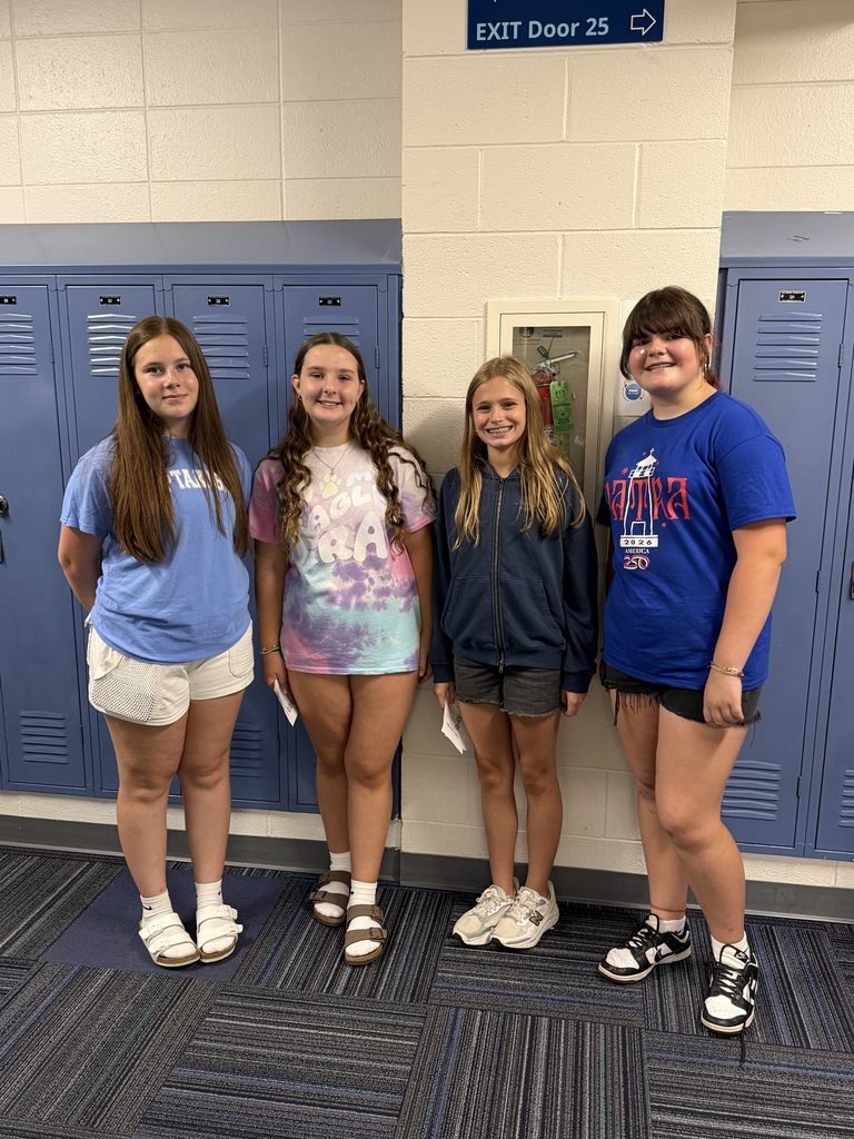 8th-grade students standing together smiling for a pic.