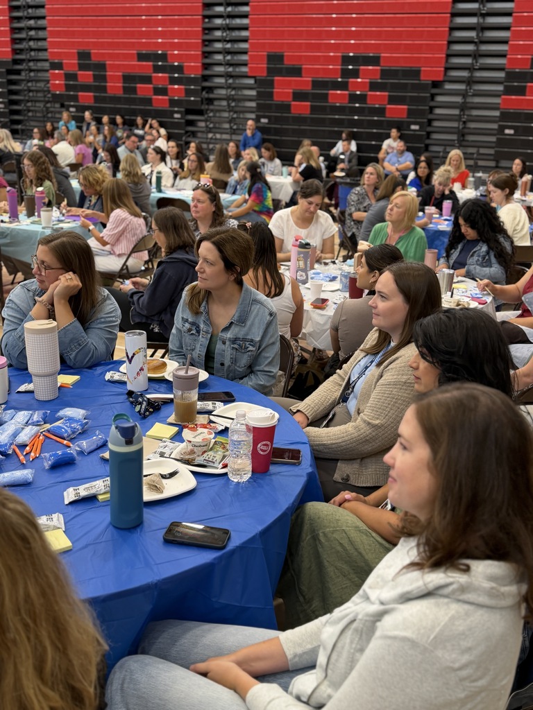 Teachers sitting and listening to Dr. M.