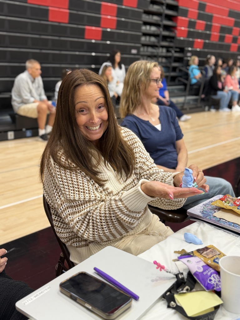 teacher holding her clay person.