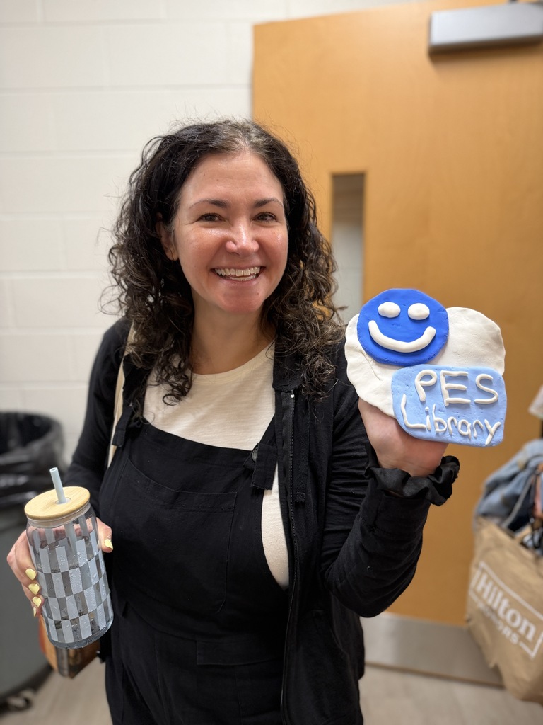 Teacher holding a PES library creation.