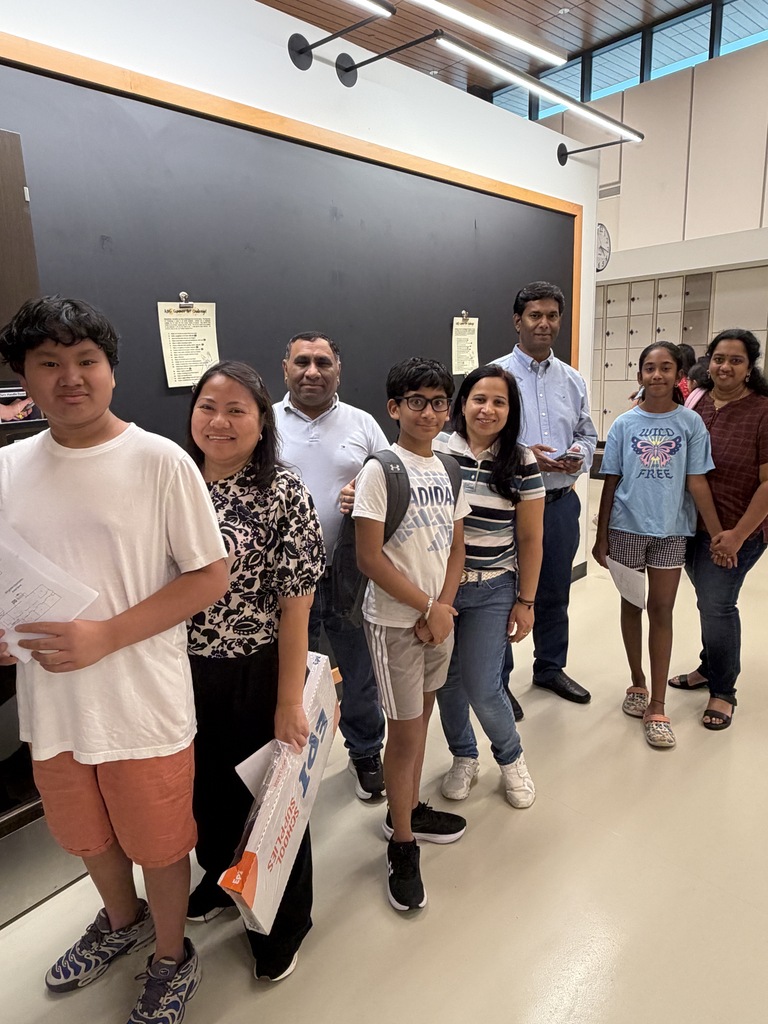 Family standing in line to meet a teacher.