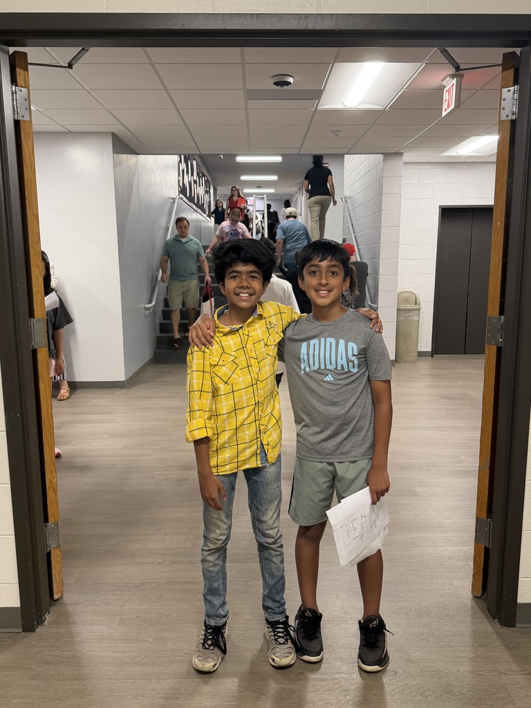 2 boys standing in the hallway at AJHS.