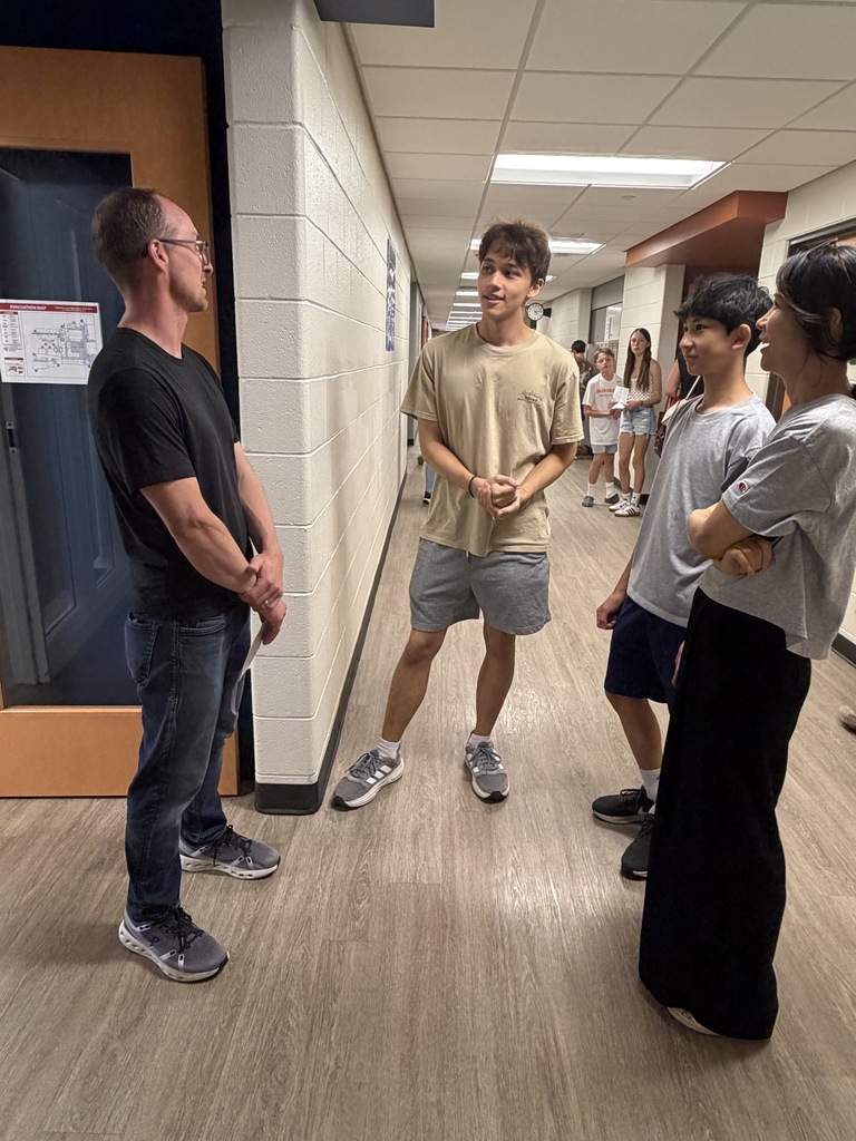 teacher talking with 3 family members