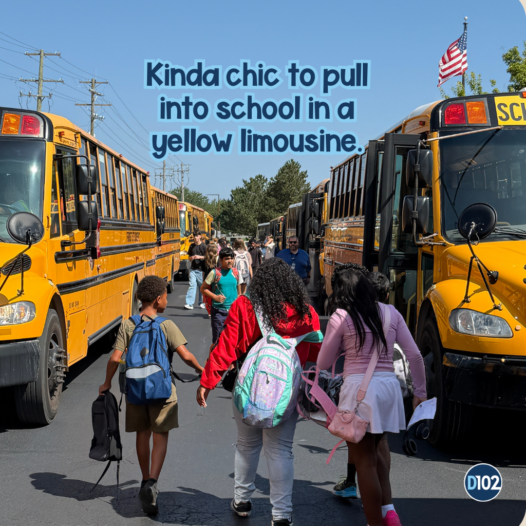 Photo of students talking to the busses.