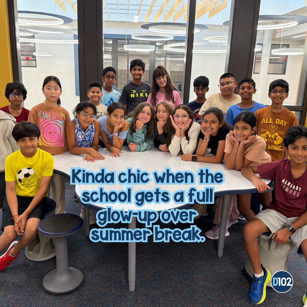 Students sitting at a table in new construction.