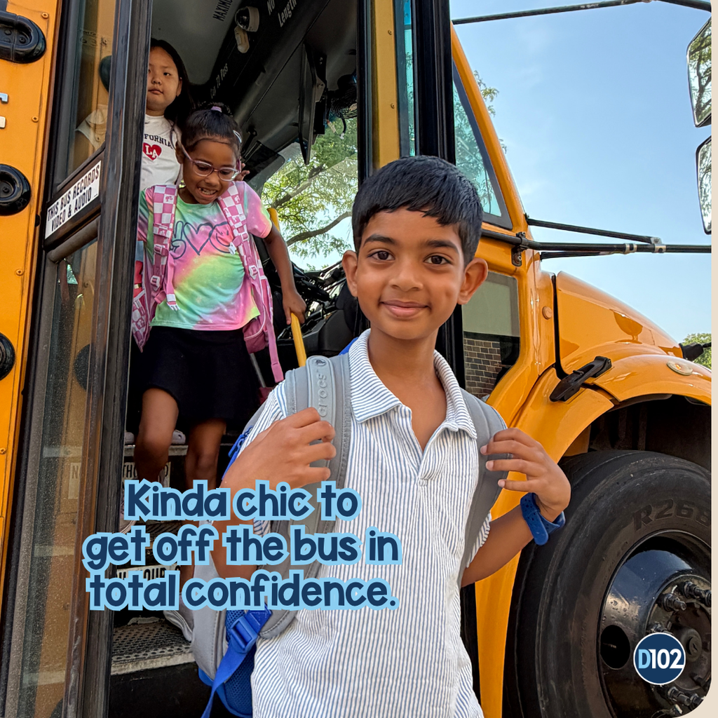 Photo of a boy getting off the bus.