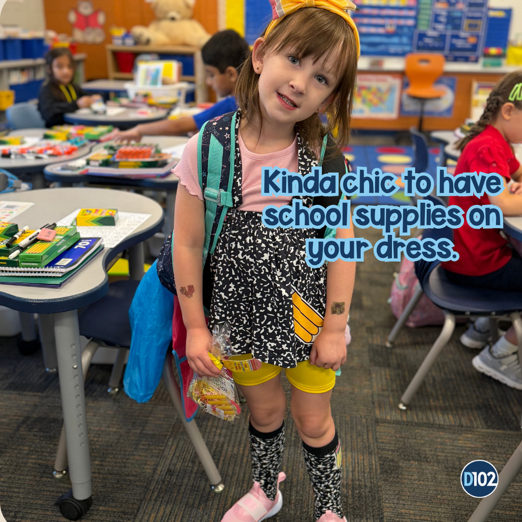 Photo of a girl wearing a dress with pencils.