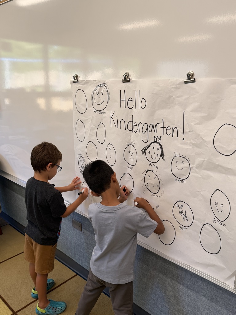 STudents drawing a picture of themselves.