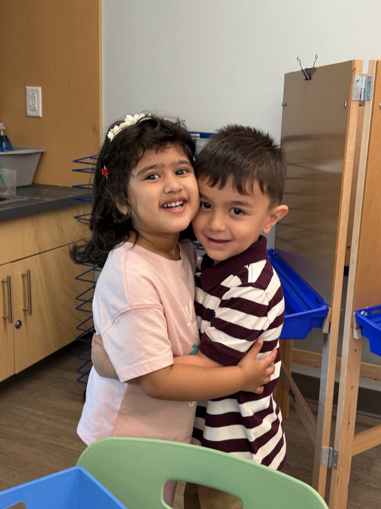 2 students (boy and girl) hugging.
