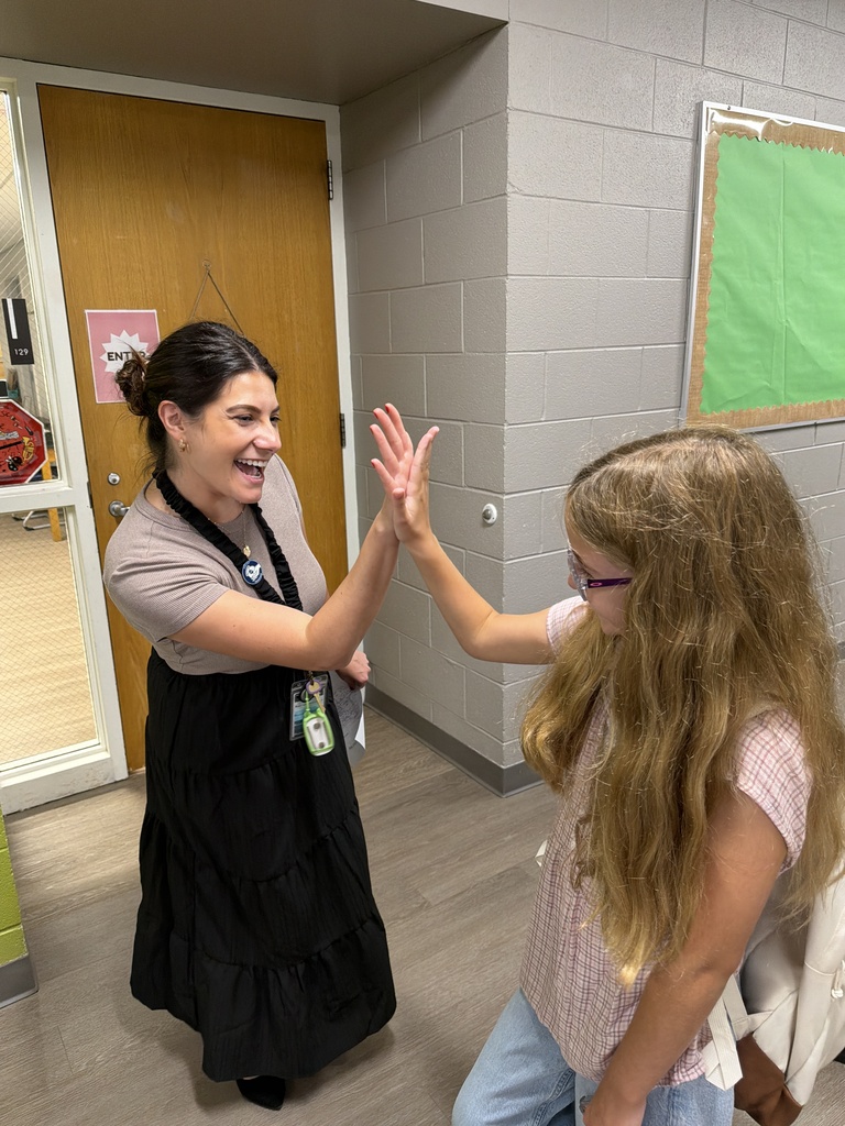 Teacher giving high five to student. 