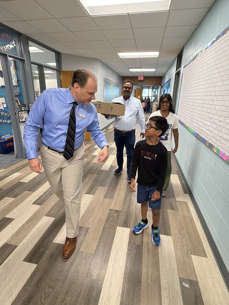 Dr. Moreland walking with a family down the hallway.
