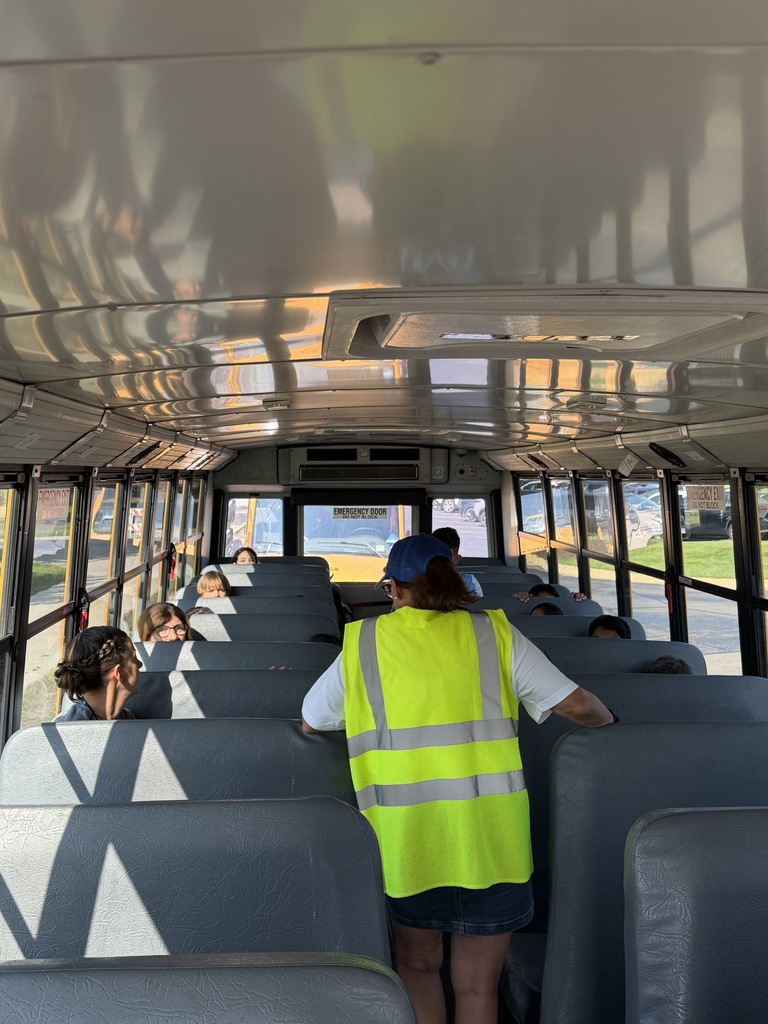 Bus driver talking to students on the 