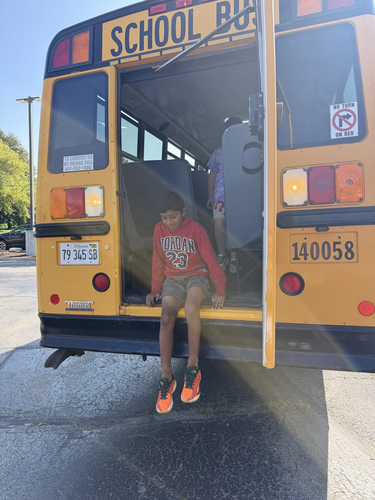 Boy hops off of back door of bus.
