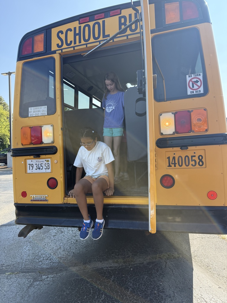 Girls hopping off the back of the bus for a drill.