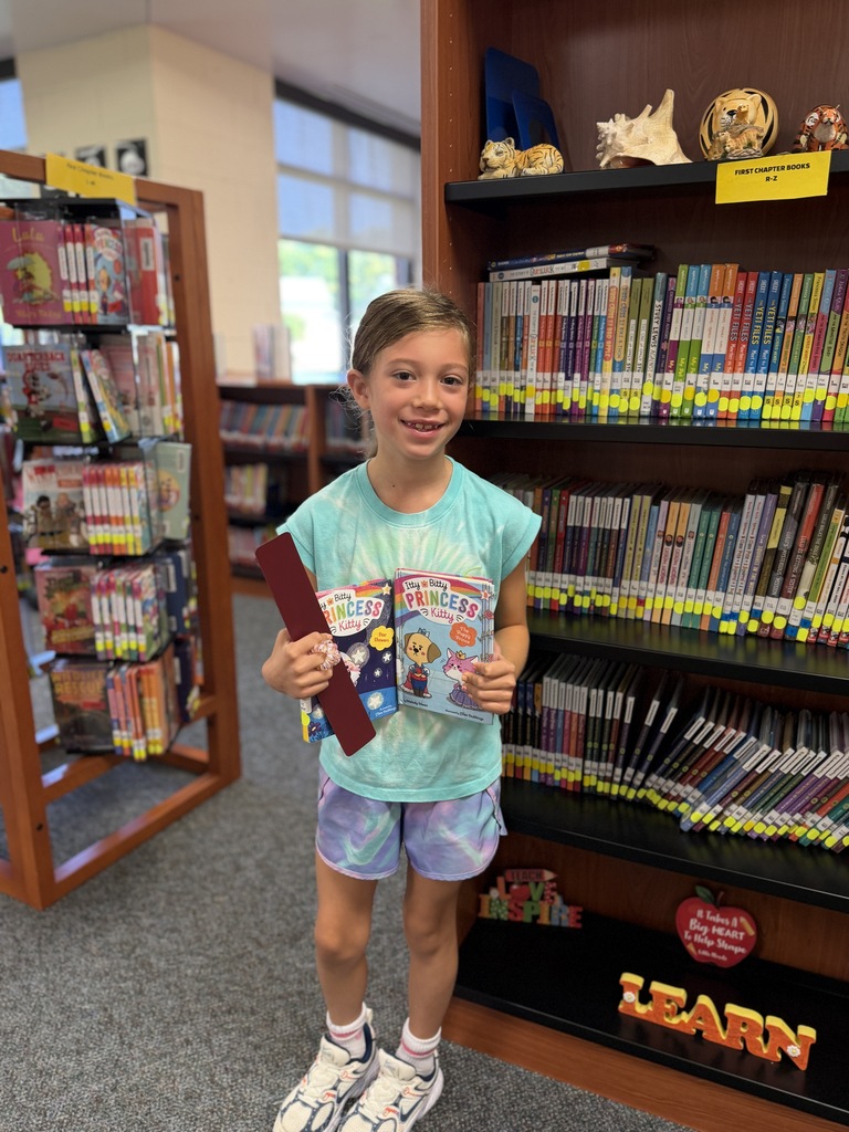 girl standing by book.