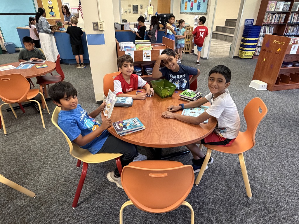 4 boys reading books.