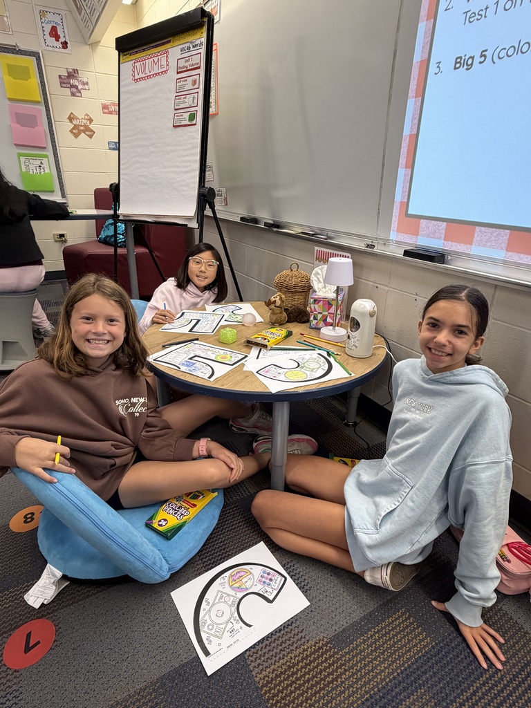 3 girls working on the floor.
